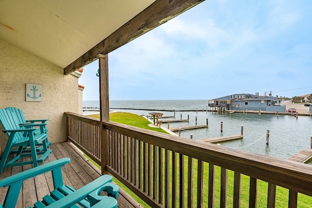 balcony featuring a water view and a dock