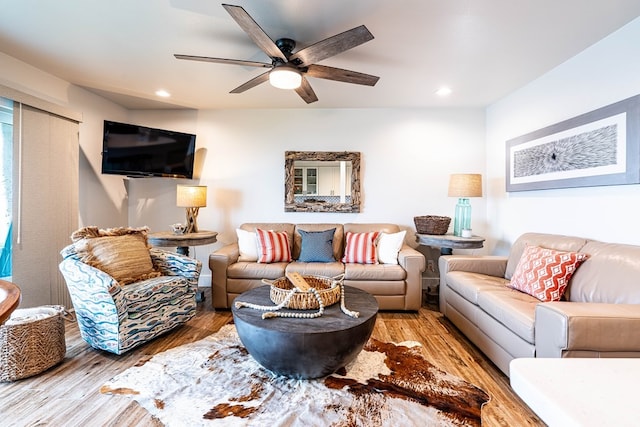 living room featuring hardwood / wood-style floors and ceiling fan