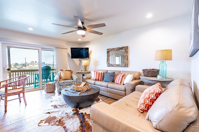 living room with hardwood / wood-style flooring and ceiling fan