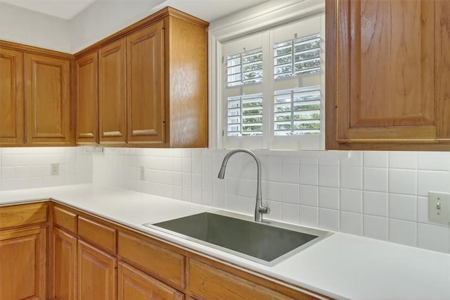 521 Del Mar Blvd, Corpus Christi, TX 78404 - kitchen with brown cabinetry, tasteful backsplash, and light countertops