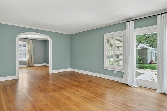 521 Del Mar Blvd, Corpus Christi, TX 78404 - unfurnished room with arched walkways, crown molding, and light wood-type flooring