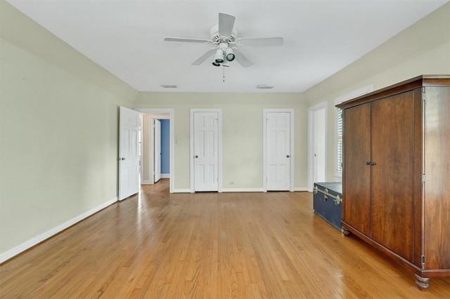 521 Del Mar Blvd, Corpus Christi, TX 78404 - unfurnished bedroom with two closets, light wood-type flooring, and ceiling fan