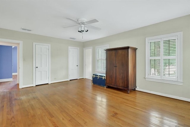521 Del Mar Blvd, Corpus Christi, TX 78404 - unfurnished bedroom with light wood-style flooring, two closets, and ceiling fan