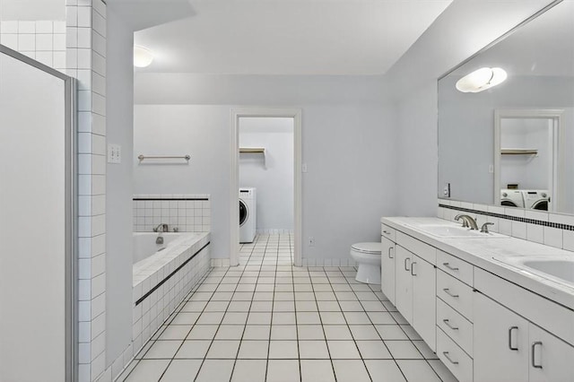521 Del Mar Blvd, Corpus Christi, TX 78404 - full bathroom featuring washer / clothes dryer, a garden tub, tile patterned floors, double vanity, and a stall shower