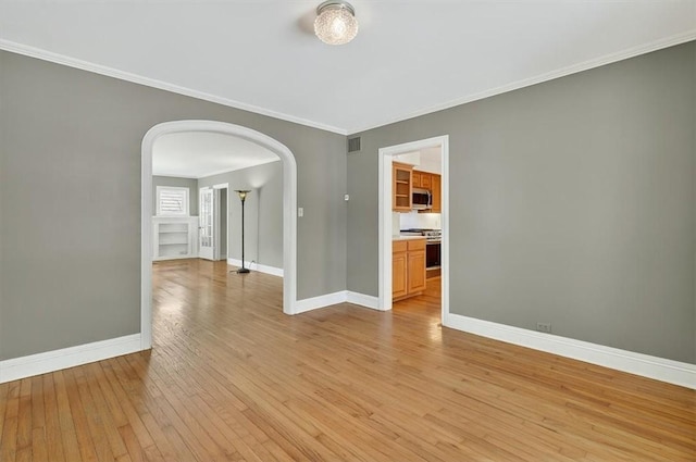 521 Del Mar Blvd, Corpus Christi, TX 78404 - unfurnished room featuring arched walkways, light wood-type flooring, and ornamental molding