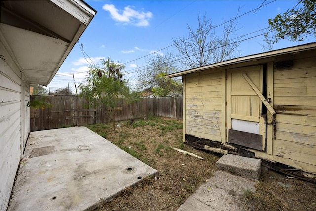 3033 Elgin St, Corpus Christi, TX 78405 - fenced backyard with a patio area and an outbuilding