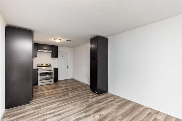 3033 Elgin St, Corpus Christi, TX 78405 - kitchen with electric range, light wood-type flooring, freestanding refrigerator, under cabinet range hood, and light countertops
