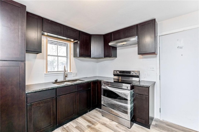 3033 Elgin St, Corpus Christi, TX 78405 - kitchen featuring stainless steel electric stove, under cabinet range hood, light wood-style flooring, dark brown cabinetry, and dark stone counters