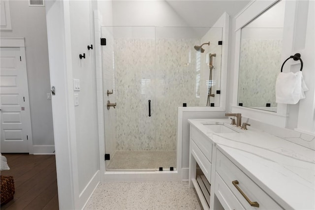 full bath with visible vents, vanity, and a shower stall