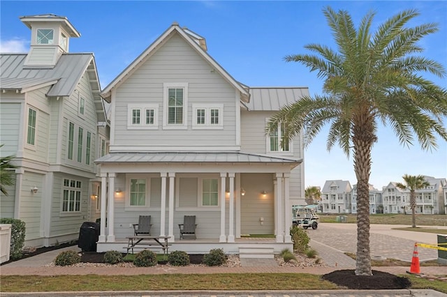 view of front of home featuring metal roof, covered porch, and a standing seam roof