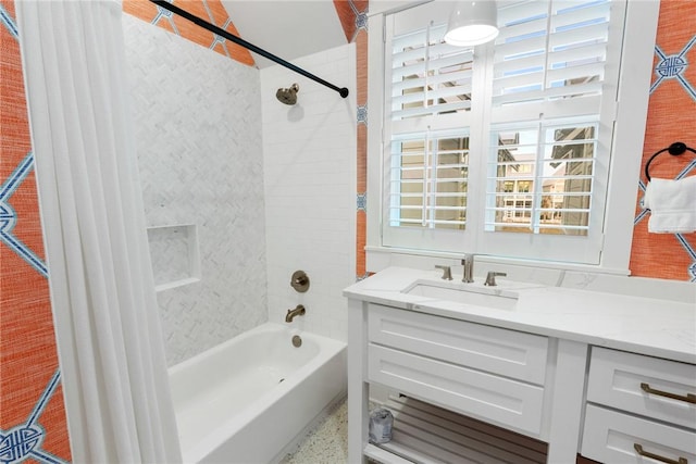 full bath with speckled floor, shower / bath combo with shower curtain, and vanity