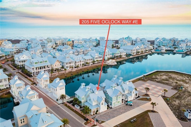 drone / aerial view featuring a residential view and a water view