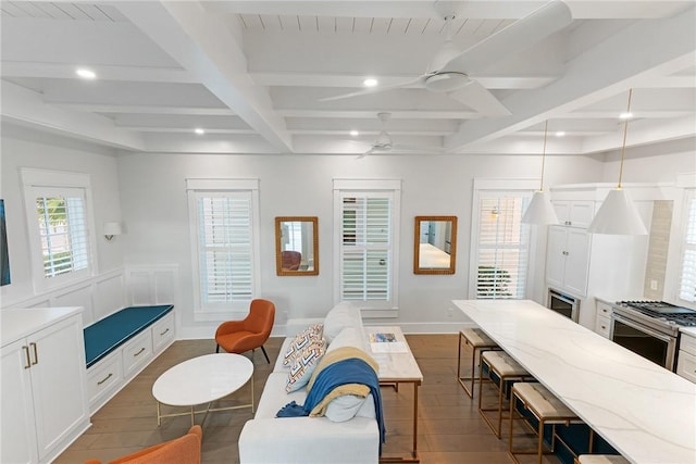 interior space featuring a kitchen breakfast bar, gas range, ceiling fan, and dark wood finished floors