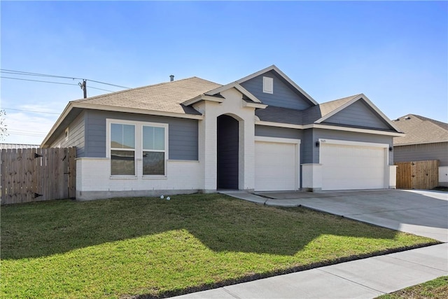 view of front of home featuring a front lawn and a garage