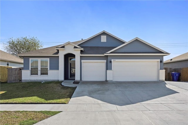 view of front of home featuring a front yard and a garage