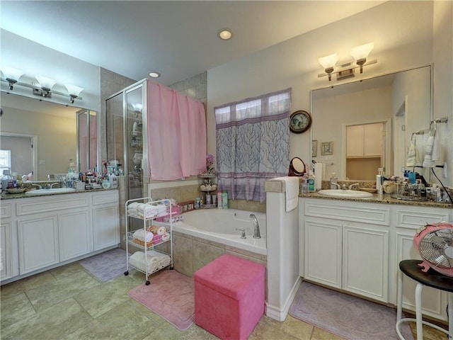 13838 Sea Horse Ave, Corpus Christi, TX 78418 - bathroom featuring a stall shower, a bath, two vanities, and recessed lighting