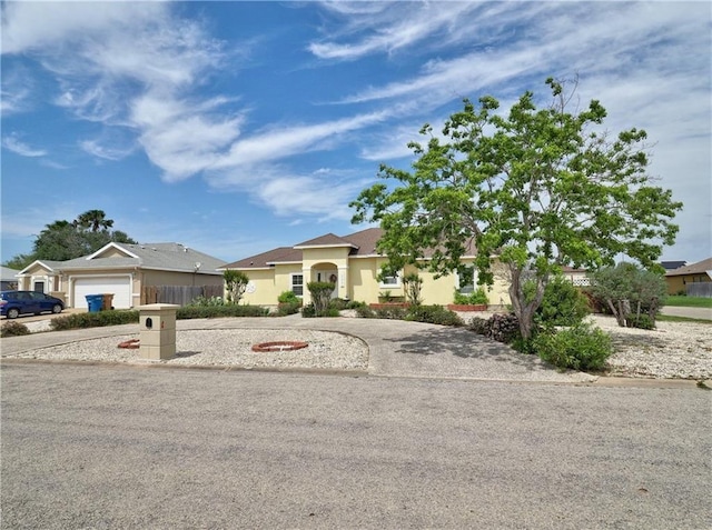 13838 Sea Horse Ave, Corpus Christi, TX 78418 - view of front facade featuring driveway, stucco siding, and a garage
