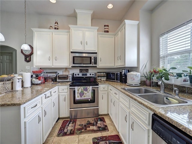 13838 Sea Horse Ave, Corpus Christi, TX 78418 - kitchen with stainless steel appliances, white cabinetry, a peninsula, pendant lighting, and recessed lighting