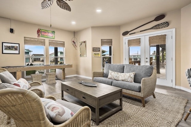 living room featuring recessed lighting, french doors, baseboards, and wood finished floors