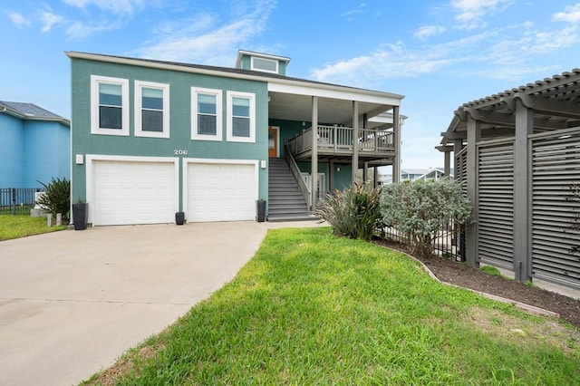 view of front facade featuring a garage, concrete driveway, a front yard, and stucco siding