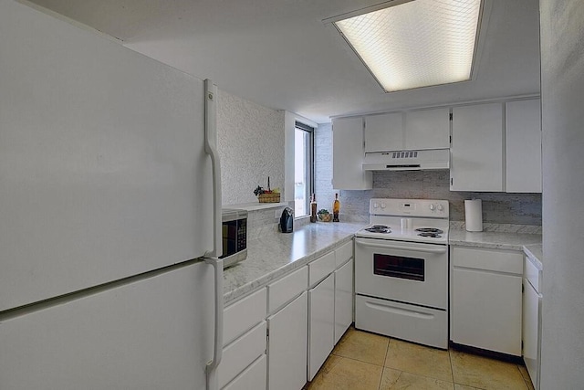 kitchen featuring white cabinetry, white appliances, and light tile patterned flooring