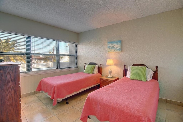 bedroom with light tile patterned floors