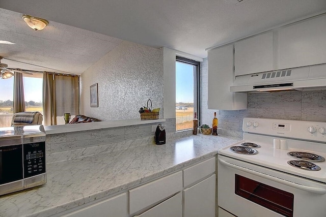 kitchen featuring light stone counters, white cabinets, white electric range, and exhaust hood