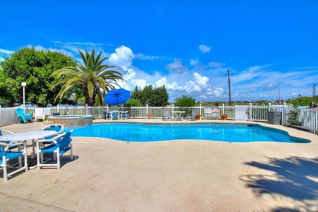 view of pool featuring an in ground hot tub and a patio