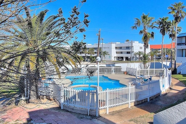 view of pool featuring a jacuzzi and a patio