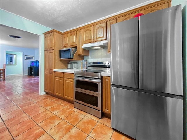 kitchen with stainless steel appliances, decorative backsplash, and light tile patterned floors