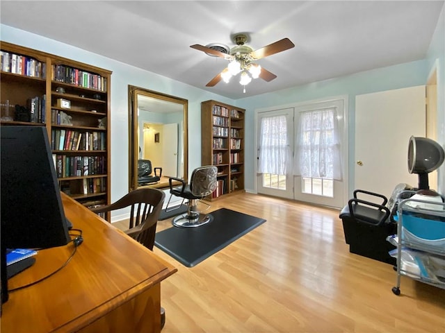 office with ceiling fan, french doors, and light hardwood / wood-style floors