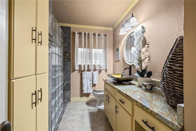1317 Easthaven Dr, Corpus Christi, TX 78412 - bathroom featuring vanity, toilet, a textured ceiling, ornamental molding, and tile patterned flooring