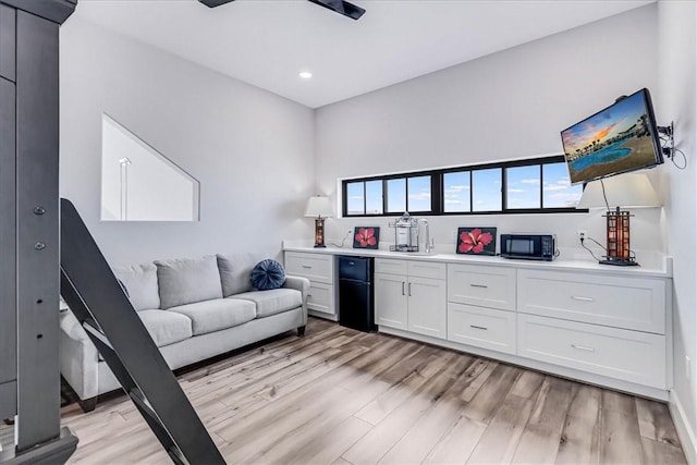 interior space featuring light wood-style flooring, recessed lighting, a dry bar, and a healthy amount of sunlight