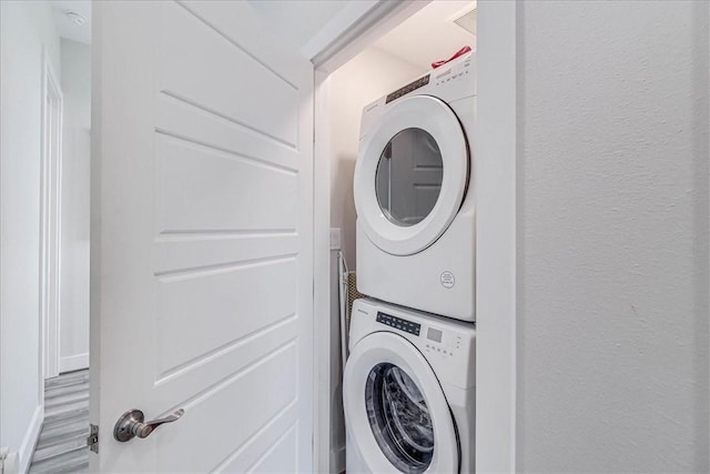 laundry area featuring stacked washer and dryer and laundry area
