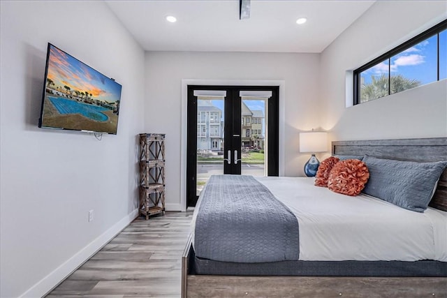 bedroom featuring recessed lighting, french doors, baseboards, and wood finished floors