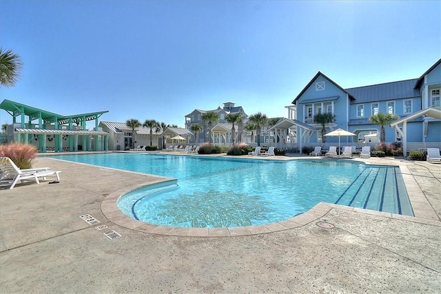 pool with a residential view and a patio area
