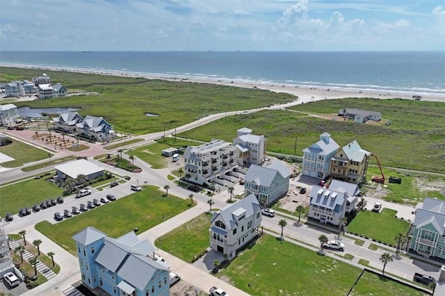 aerial view with a water view and a view of the beach