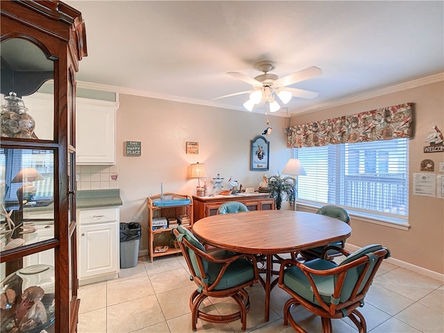 dining area featuring ceiling fan, light tile patterned floors, and crown molding