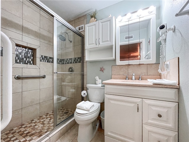 bathroom with backsplash, vanity, an enclosed shower, tile patterned floors, and toilet