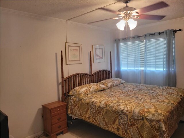 bedroom featuring a textured ceiling, ceiling fan, and ornamental molding