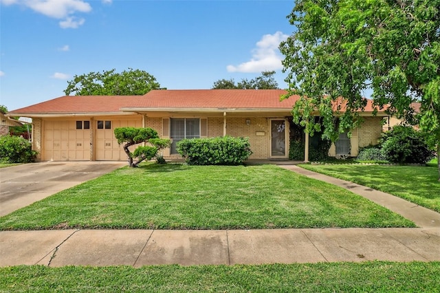 4634 Bonner Dr, Corpus Christi, TX 78411 - ranch-style home featuring a garage, driveway, brick siding, and a front yard