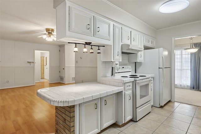 4634 Bonner Dr, Corpus Christi, TX 78411 - kitchen with white range with electric stovetop, under cabinet range hood, tile countertops, ceiling fan, and backsplash