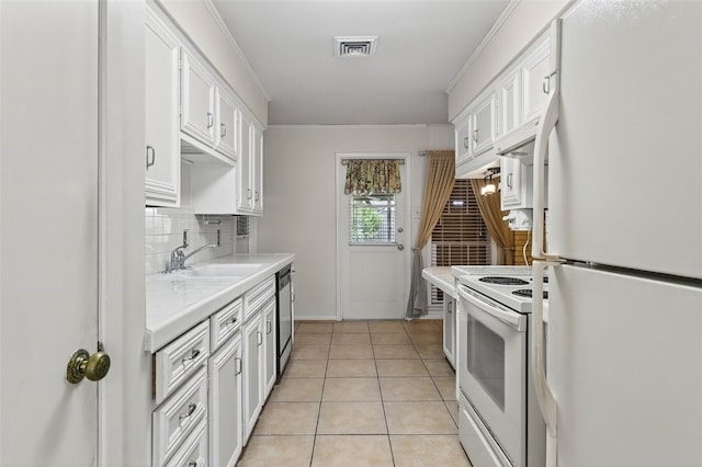 4634 Bonner Dr, Corpus Christi, TX 78411 - kitchen featuring white appliances, white cabinetry, tasteful backsplash, ornamental molding, and light tile patterned floors