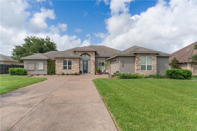 5806 Lago Vista Dr, Corpus Christi, TX 78414 - view of front facade featuring stone siding, driveway, an attached garage, and stucco siding