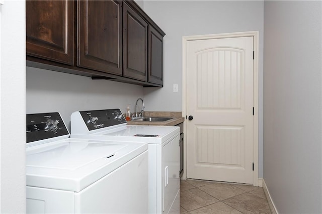 5806 Lago Vista Dr, Corpus Christi, TX 78414 - washroom featuring washer and clothes dryer, cabinet space, and light tile patterned flooring