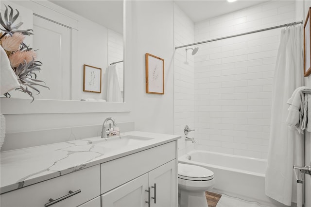 full bathroom with vanity, shower / bath combo, and toilet