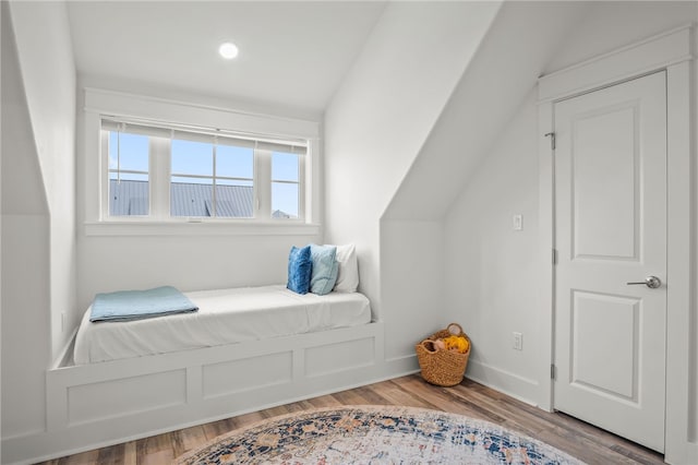 bedroom with lofted ceiling and light hardwood / wood-style flooring