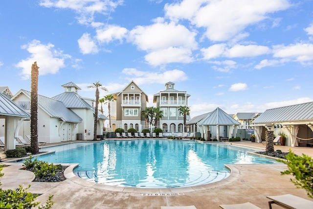 view of swimming pool featuring a patio and a gazebo