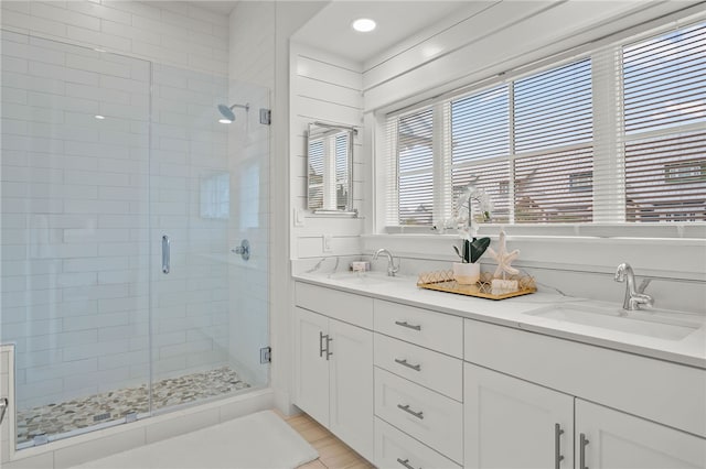 bathroom featuring vanity and an enclosed shower