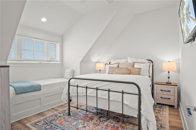 bedroom featuring lofted ceiling, wood-type flooring, and ceiling fan